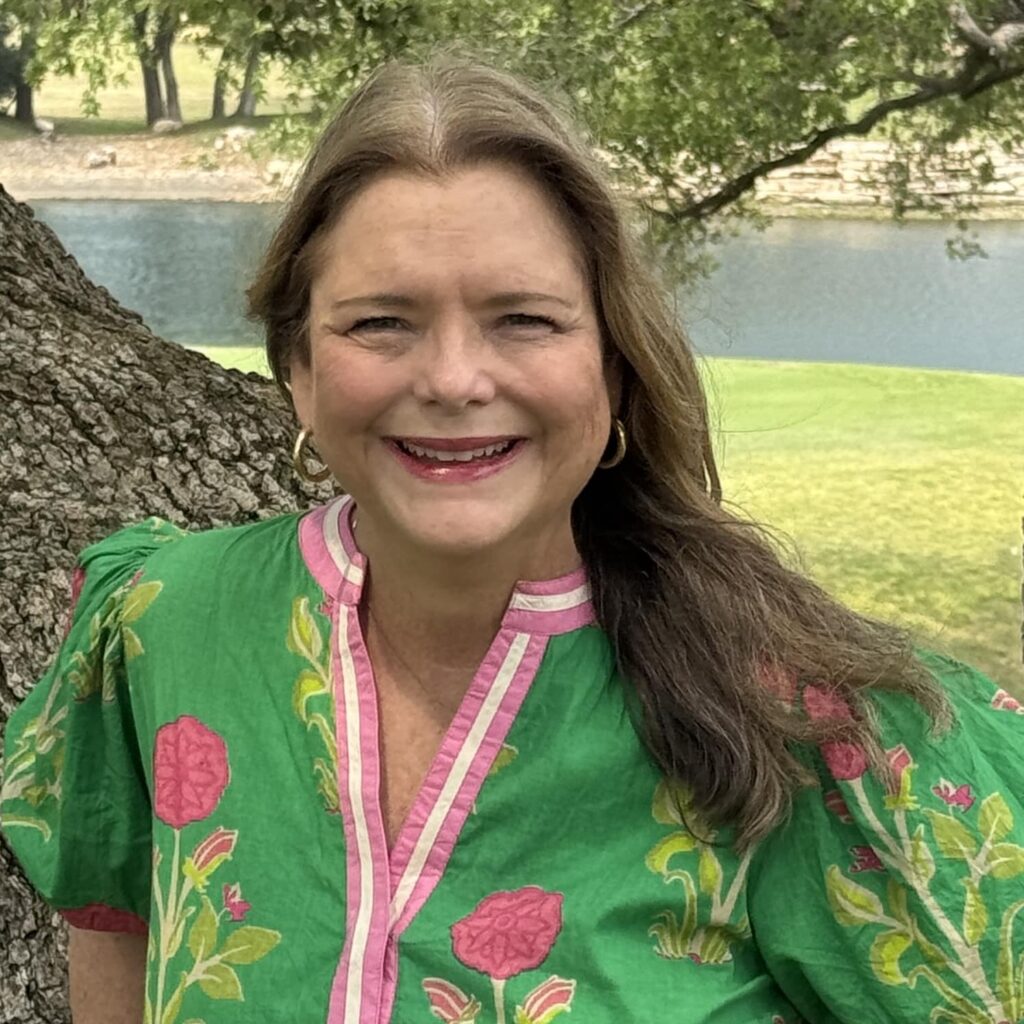 Headshot of Louisa Hametner, standing in front of a large tree near a river.